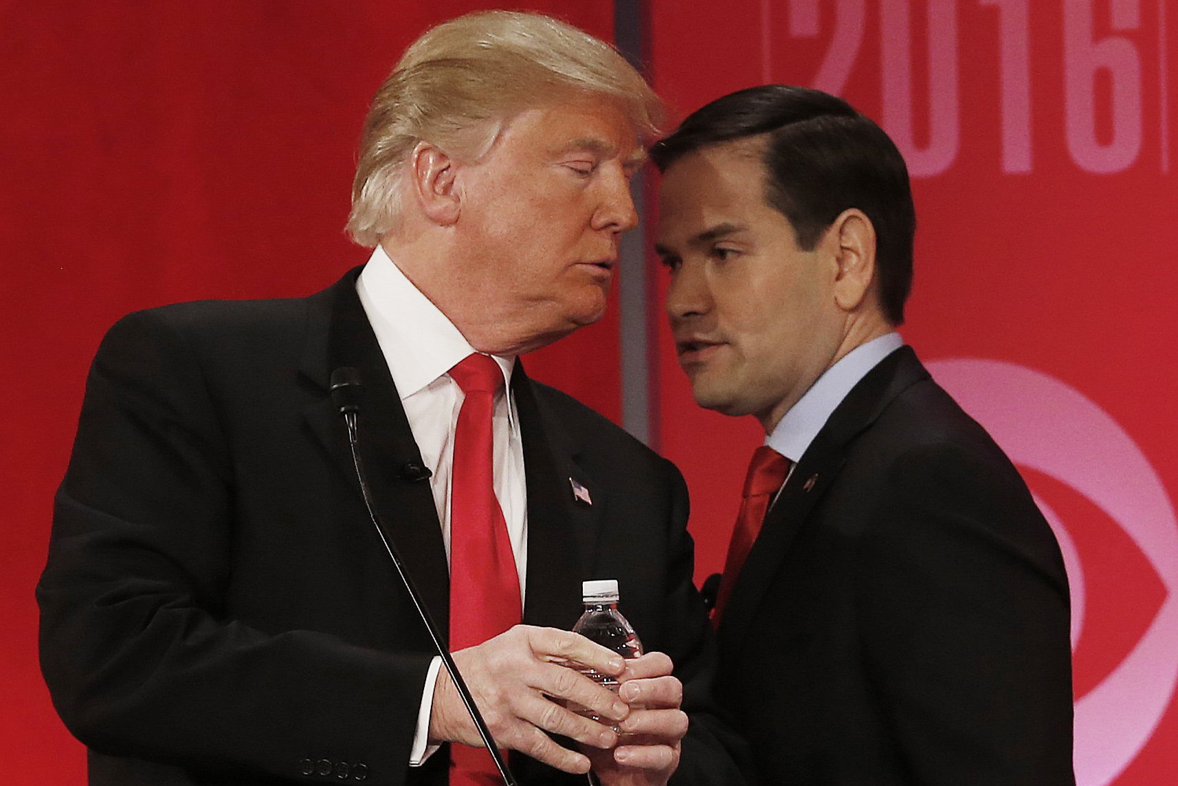 Republican presidential candidate, Sen. Marco Rubio, R-Fla., right, right, speaks to Republican presidential candidate, businessman Donald Trump during a commercial break during the CBS News Republican presidential debate at the Peace Center, Saturday, Feb. 13, 2016, in Greenville, S.C. (AP Photo/John Bazemore)