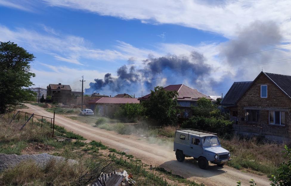 Smoke rises after explosions were heard from the direction of a Russian military airbase near Novofedorivka, Crimea August 9, 2022. REUTERS/Stringer
