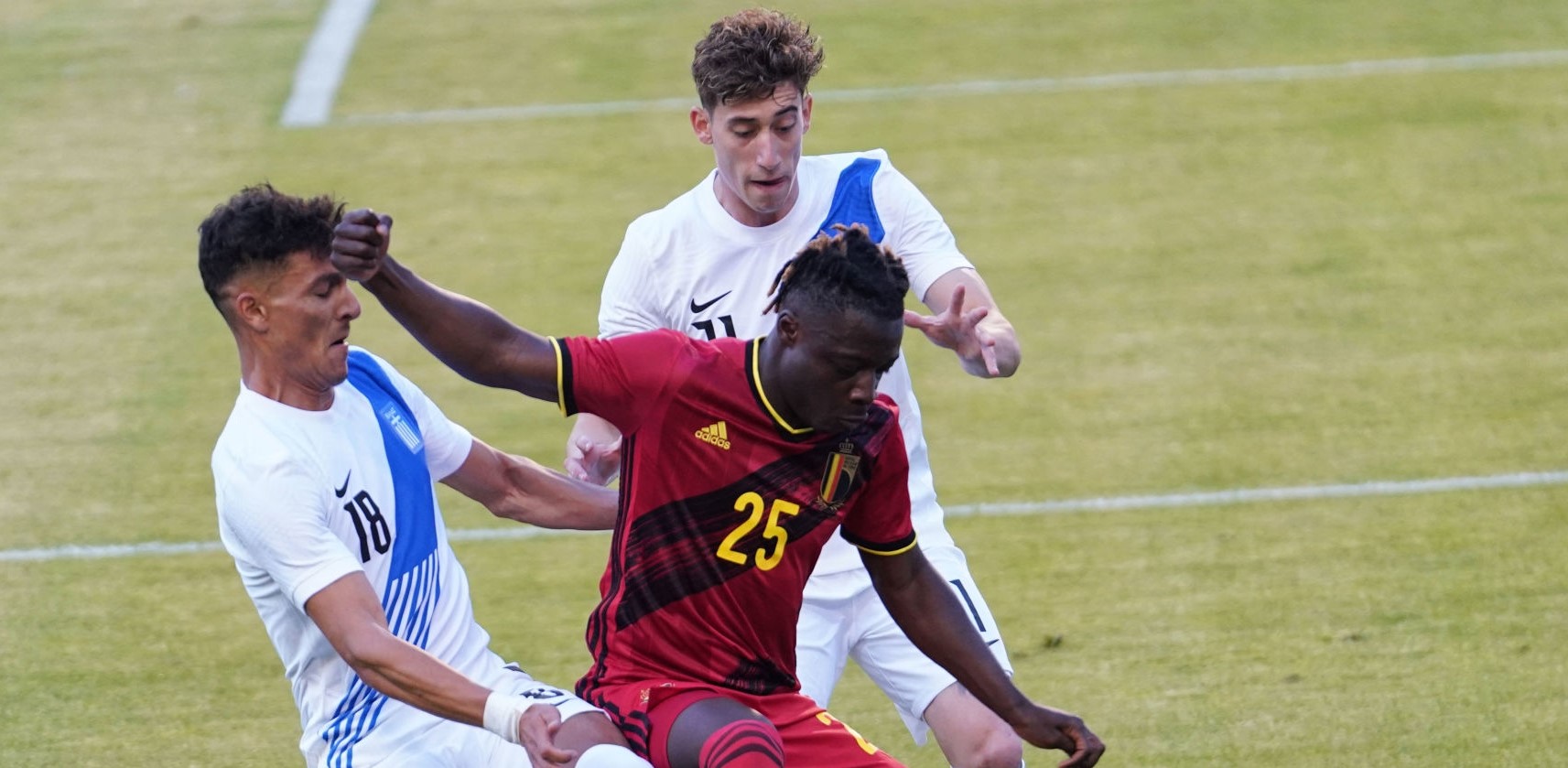 BRUSSELS, BELGIUM - JUNE 03: Jeremy Doku of Belgium competes for the ball with Dimitris Giannoulis of Greece and Kostas (Konstantinos) Tsimikas of Greece during the international friendly match between Belgium and Greece at King Baudouin Stadium on June 3, 2021 in Brussels, Belgium. (Photo by Sylvain Lefevre/Getty Images)